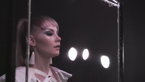 close-up: pretty girl does tricks with soap bubbles. she blows a bubble through soap curtain