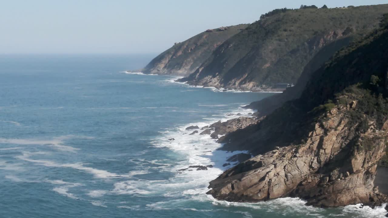 South Africa Wilderness Coastline with Green Mountains and Ocean Waves crashing on rocks