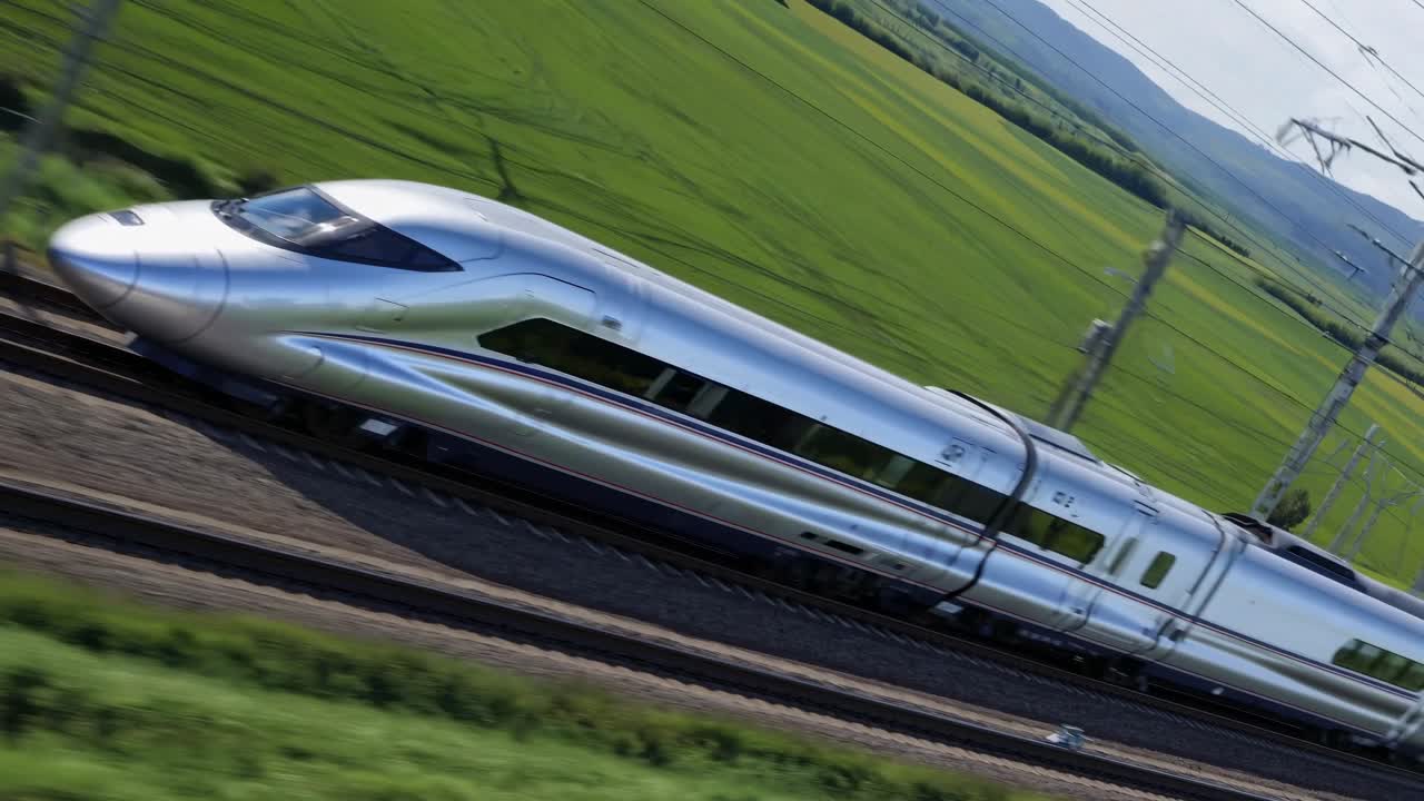Dynamic video concept of a high-speed train in motion, captured from a high-angle, showcasing sleek