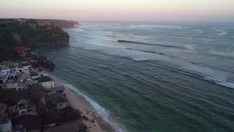 uluwatu bali island coastline drone reveal scenic luxury resort and big waves for professional surfer