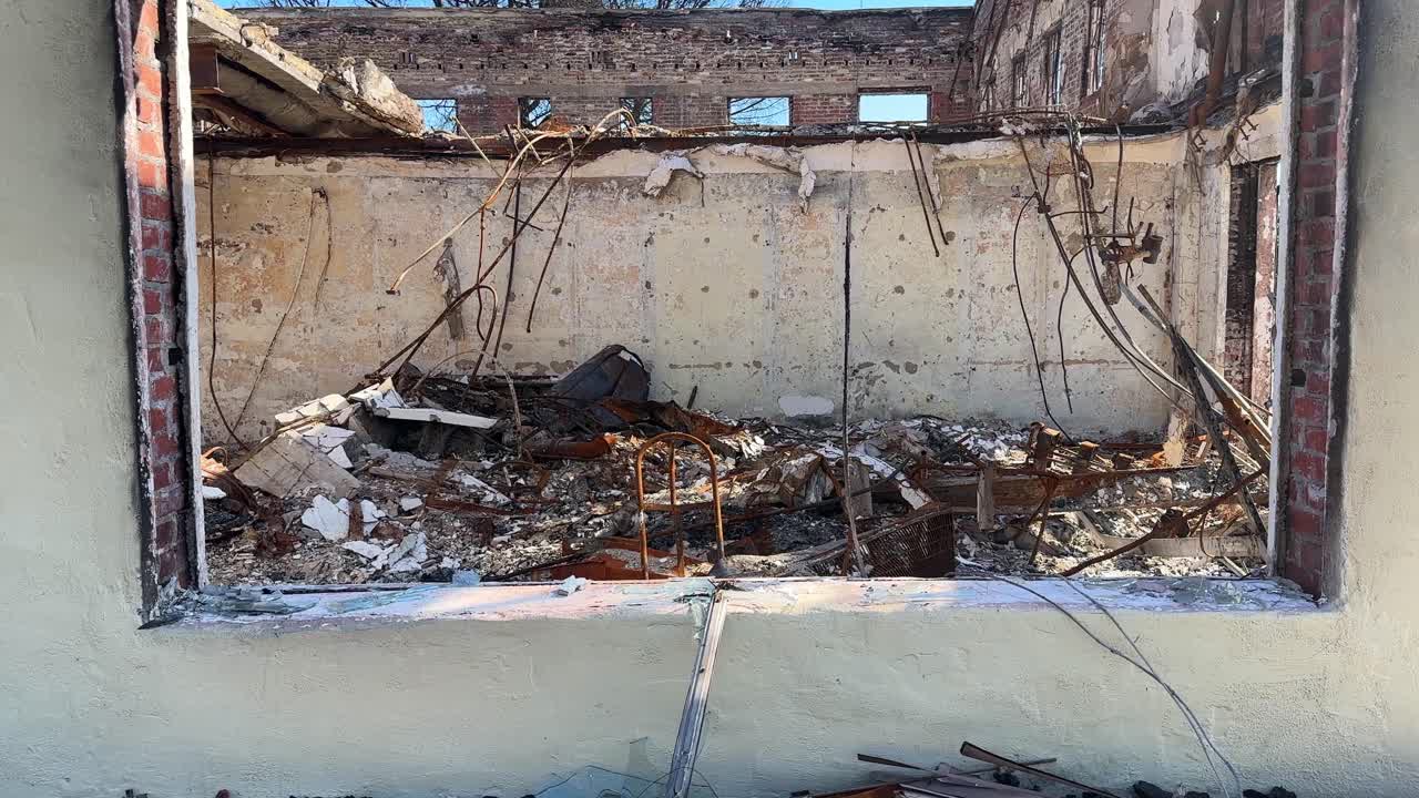Handheld close-up and booming up shot of a burned business on Lake Street in Altadena, California. 4K