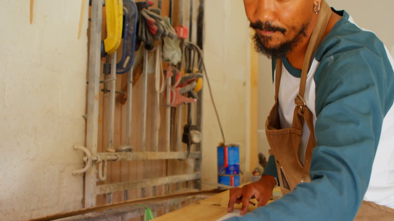 Surfboard maker working in workshop 4k