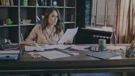 beautiful woman analyzing business documents at office. paperwork