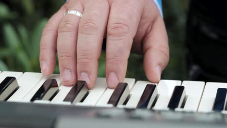 close up shot of a hand playing a keyboard