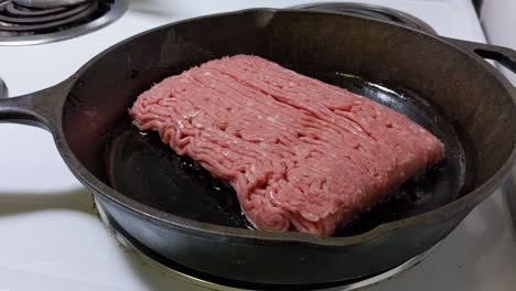 frying ground beef on a cast iron skillet