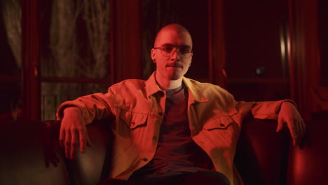 man in yellow jacket, red lighting