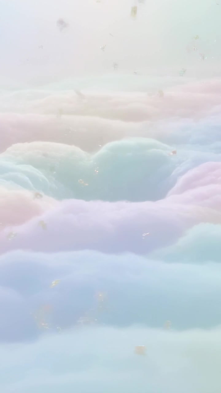 Vertical video: Camera panning pastel clouds in sky, revealing central hollow and drifting specks