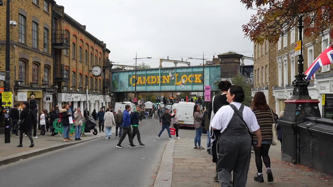 Tourists stroll through Camden Town towards the bustling street market and Camden Lock bridge