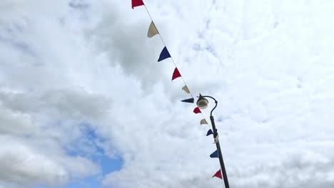 colorful flags waving against cloudy sky