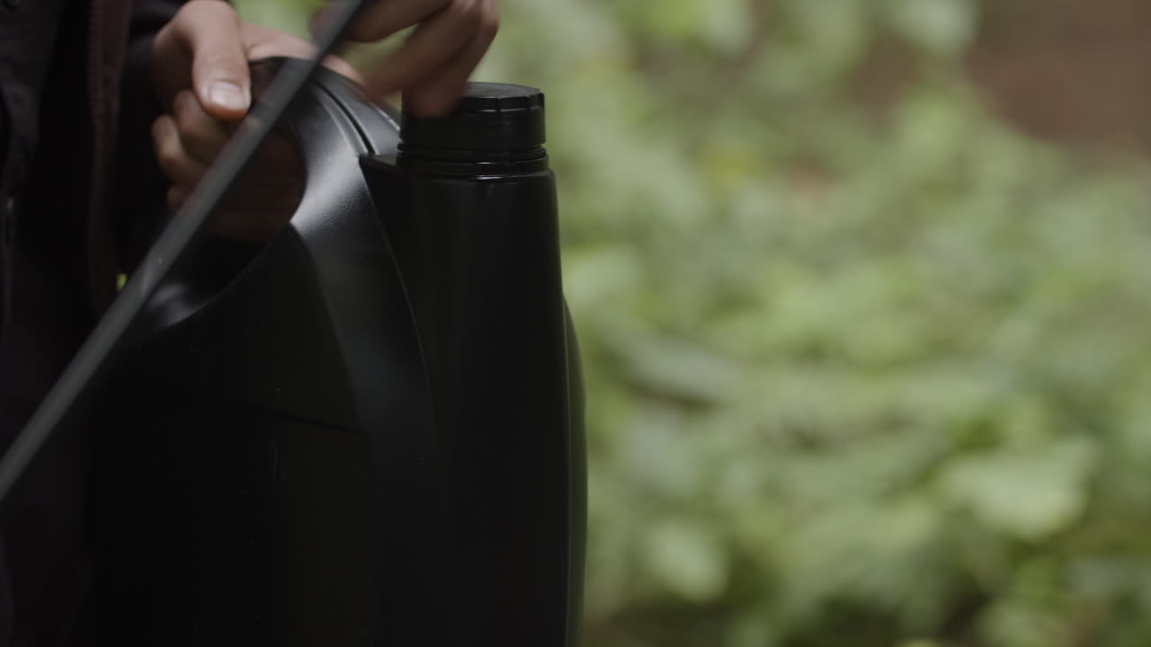 Black container with lid in forest