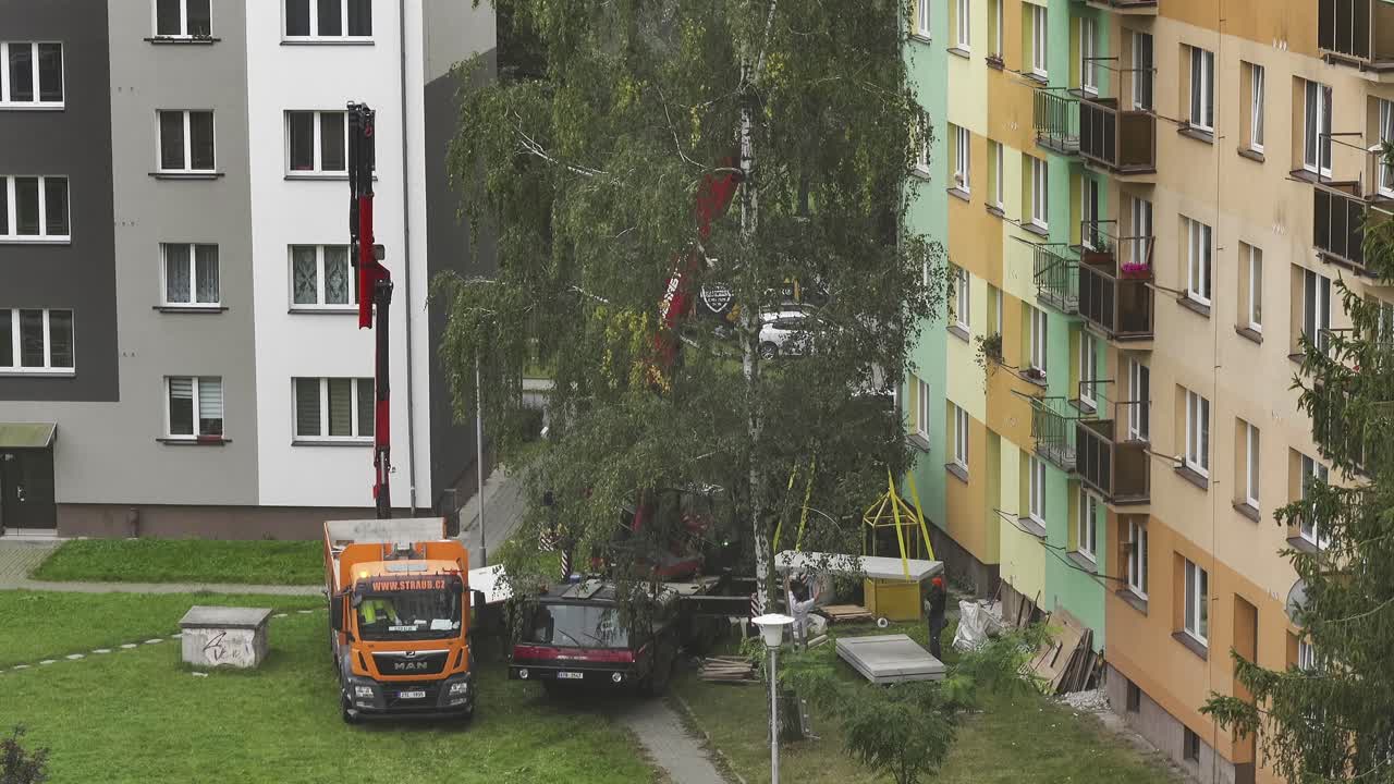 Construction work with trucks and cranes in a residential area