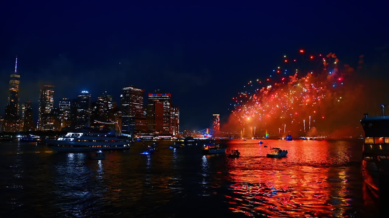 Motorboats and riverboats stand on the dark waterscape of the East River at night. Watching beautiful fireworks in New York, USA