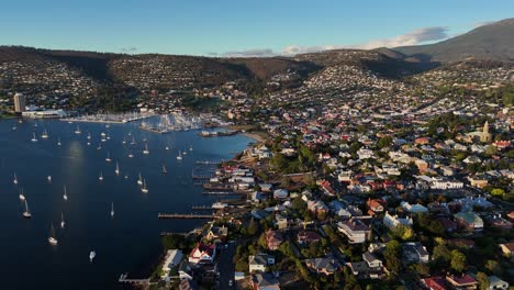sailboats at sandy bay in hobart city during sunset, tasmania, aerial shot
