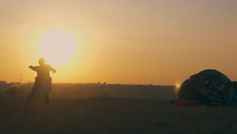 plump lady silhouette dances under orange setting sun