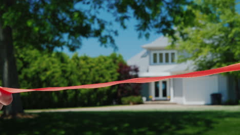 cut a traditional red ribbon at the grand opening and housewarming in a new home