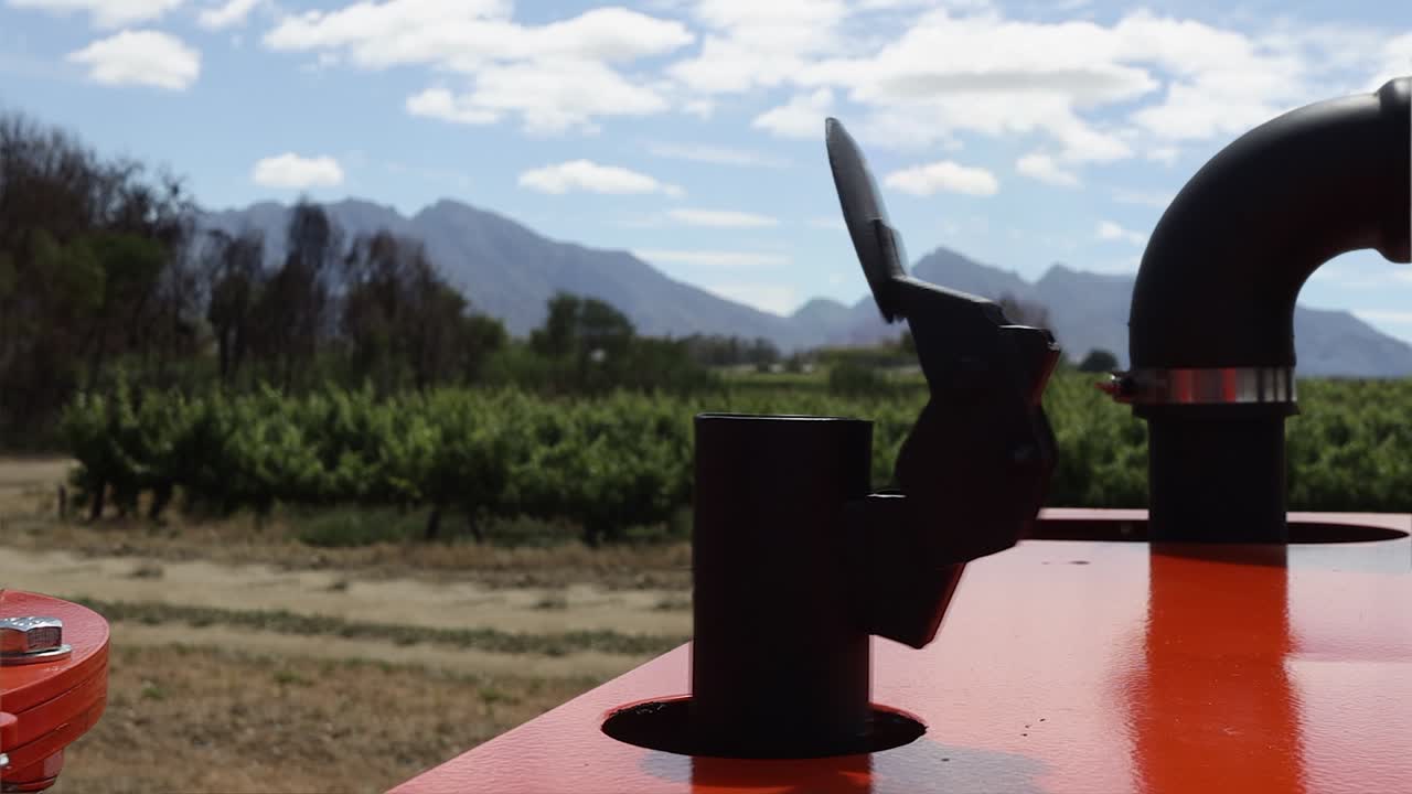 Diesel machinery exhaust pipe vibrates as equipment runs on rural farm