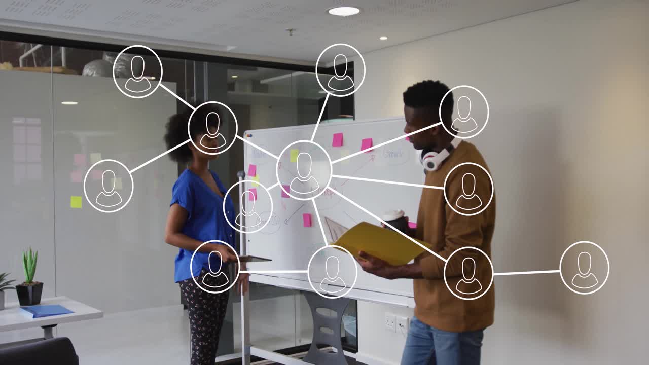 Two colleagues collaborating beside whiteboard in business session, showing floating sticky charts