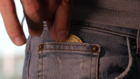 a golden bitcoin being put into a mans