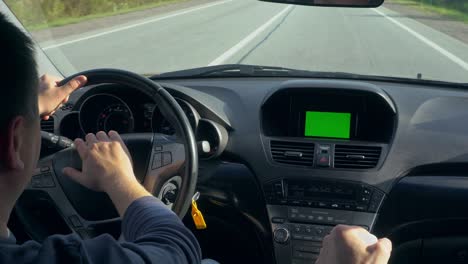 inside a car. a gps module is on. green screen