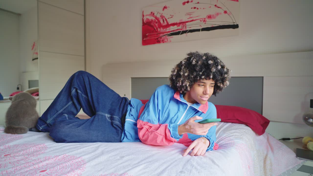 A woman relaxing on a bed with her cat