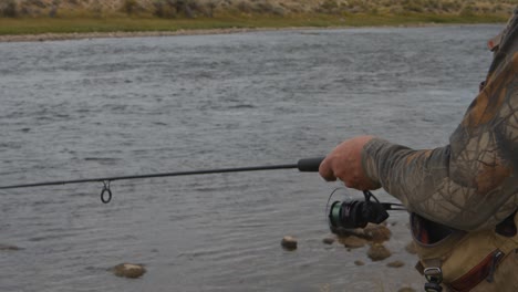 a man fishing on the miracle mile river in wyoming