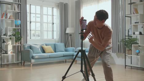 young man dancing and vlogging at home
