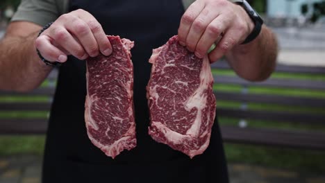 preparing raw rib-eye steaks