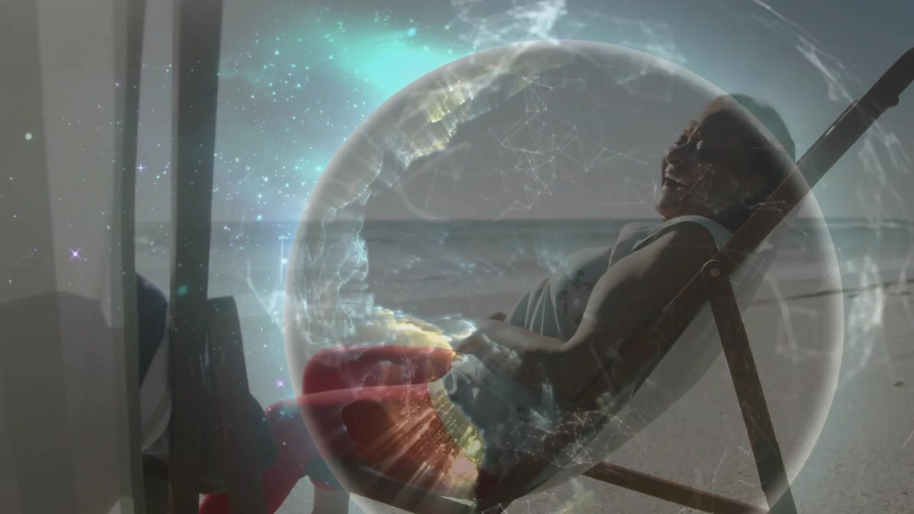 Woman reclining on patio while friend raising hand and starting globe overlay demoing tech