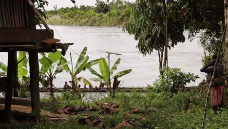 Indigenous-people-arriving-to-their-village-on-a-canoe-in-the-jungle,-Papua