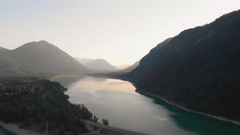a-professional-looking-aerial-shot-of-Sylvenseinsee-in-the-austrian-alps,-while-sunset