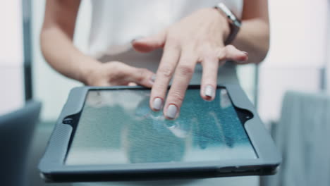 Business-woman-using-digital-tablet-walking-through-busy-office-touchscreen-display-manipulating-3d-shape