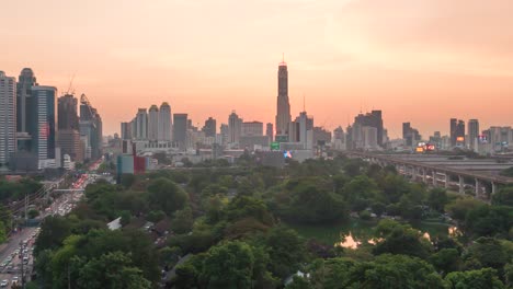 epic sunset time lapse of skyline and skyscrapers while sky turning red and sun disappering behind the ari district in bangkok, thailand