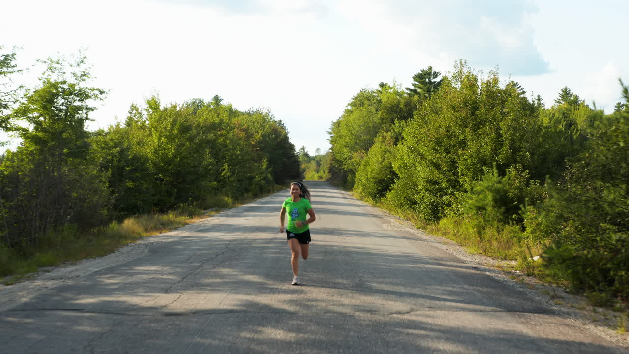Stunning tracking shot of a young woman jogging