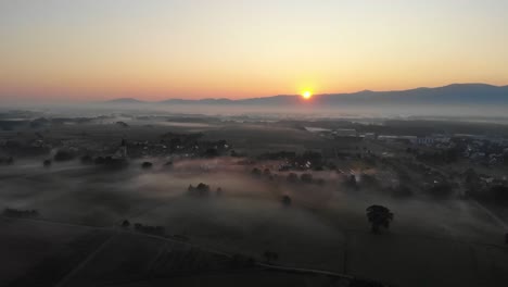 village surrounded by clouds of fog