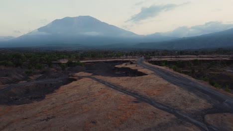 Kubu-savanna-with-mount-agung-in-the-background-during-sunset,-aerial-view