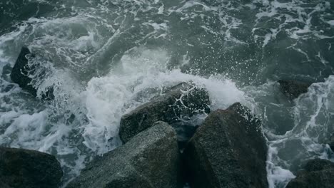 waves submerging the jagged rocks