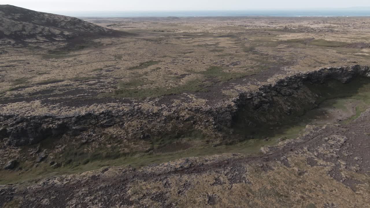 Flying above crater, lava fields, wild river in Snaefellsjokull park
