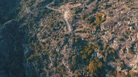 A-drone-video-captures-stunning-views-of-mountainous-landscapes-with-a-river-flowing-through-the-heart-of-nature