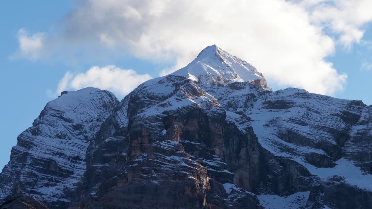 snowy mountain peaks in the swiss alps. Blue sky and clouds. Aerial video. Mountain adventure and landscapes. Aerial video at daytime