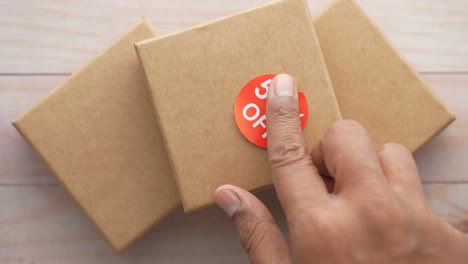 Top-view-of-50-percent-discount-sign-on-a-box-on-table