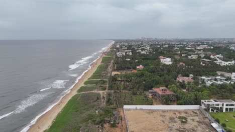long coastline framed by colorful rooftops and lush greenery in urban city