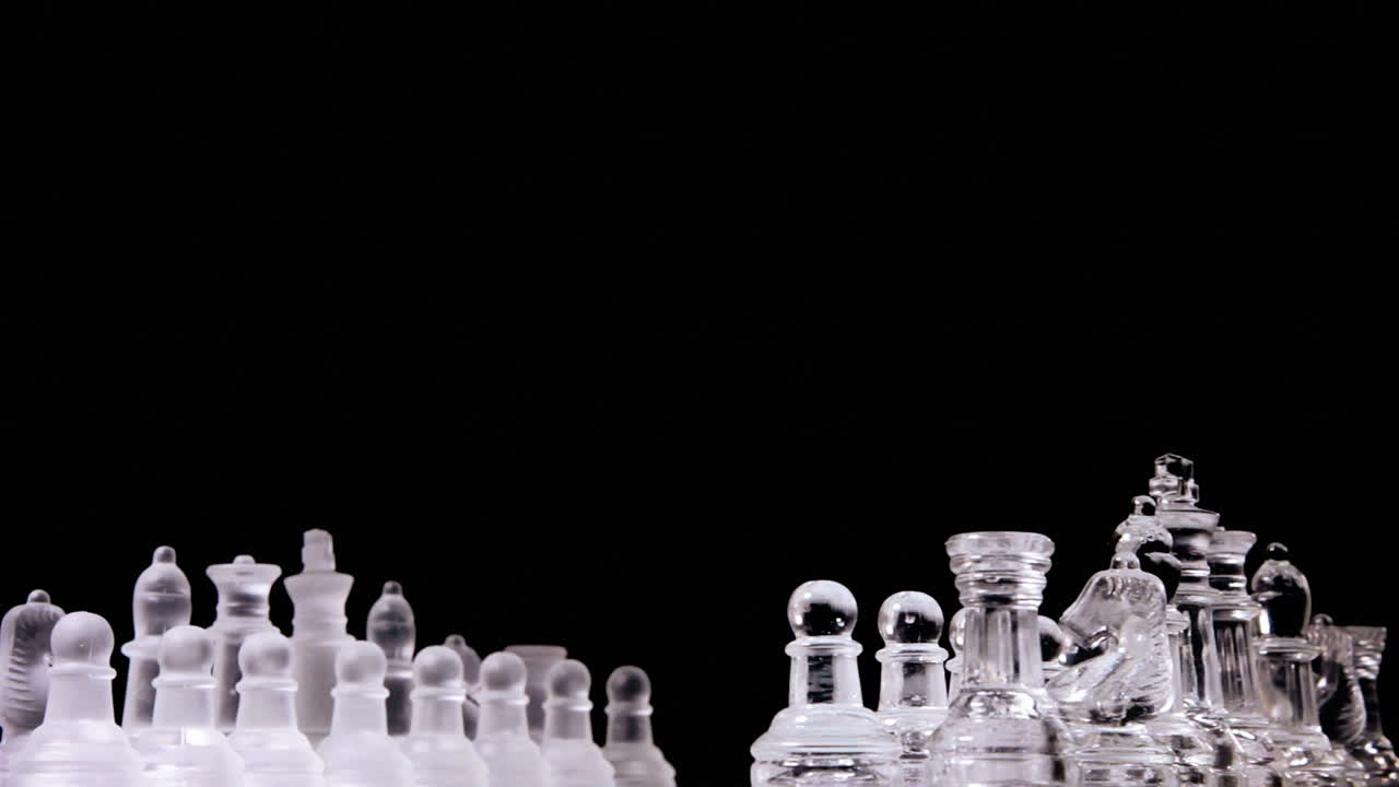 A magnificent chessboard with two different full sets of chess pieces made of glass, rotating into a starting position for one player to the equivalent for the other