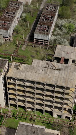 aerial view of ruined old factory. aerial shot of big abandoned factory. vertical video