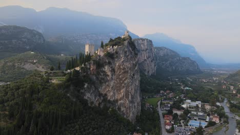 ancient arco castle on top of cliff above riva del garda city, trentino, italy