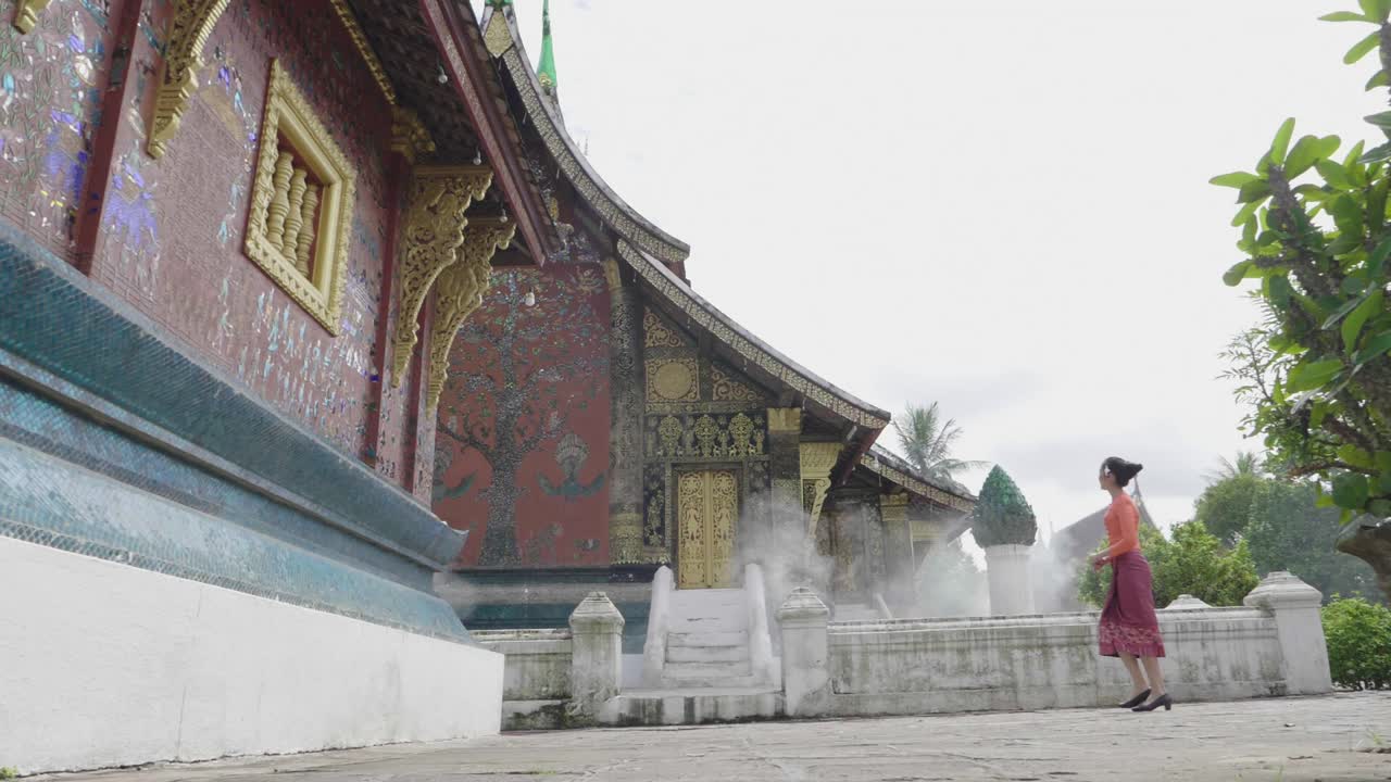 Lao Girl Walking At Wat Xieng Thong Landmark In Luang Prabang, Slow Motion