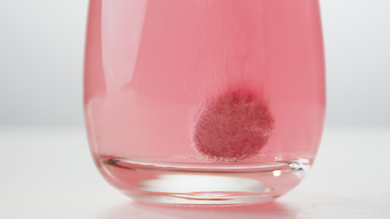 Pink Tablet Dissolving in Water
