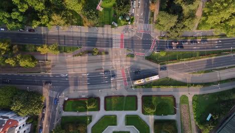 aerial view of a city intersection with park and tram