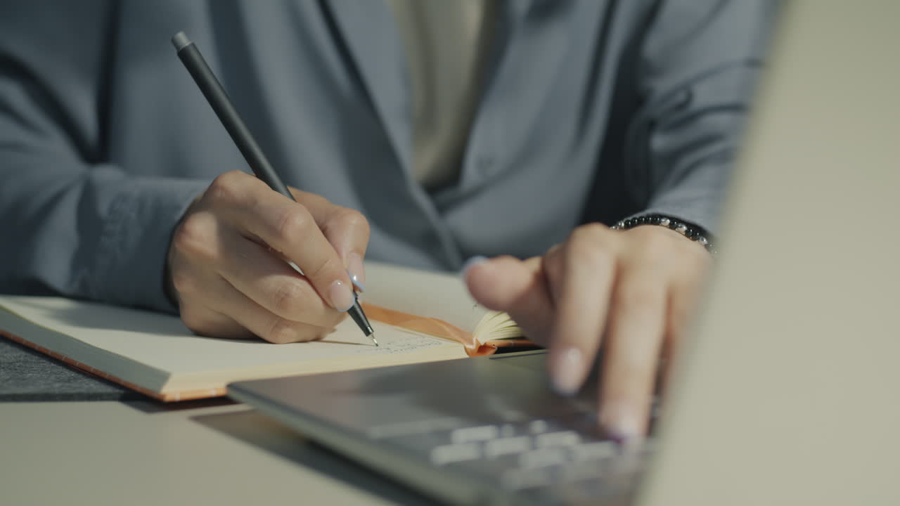 Woman working on laptop and notebook