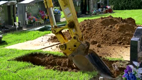 heavy machinery and digger deployed to prepare the cemetery and tombstone for funeral burial