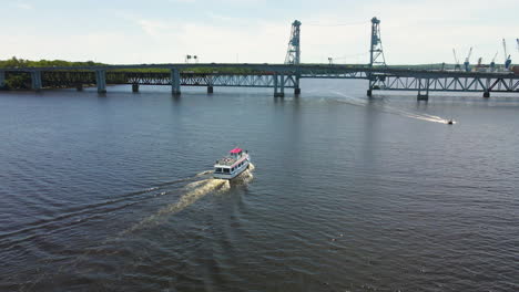 Low-Perspective-drone-shot-of-the-Merry-Meeting-Boat-heading-towards-the-Sagadahoc-Bridge